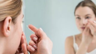 コンタクトをはめようとしている女性
